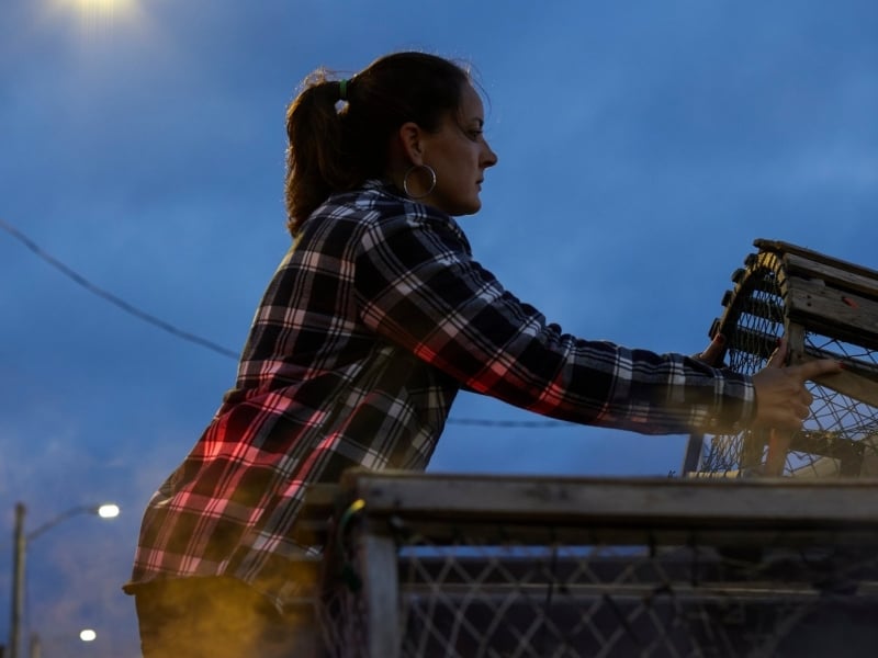 Bethany McCarthy hauls a lobster trap at dawn on the wharf