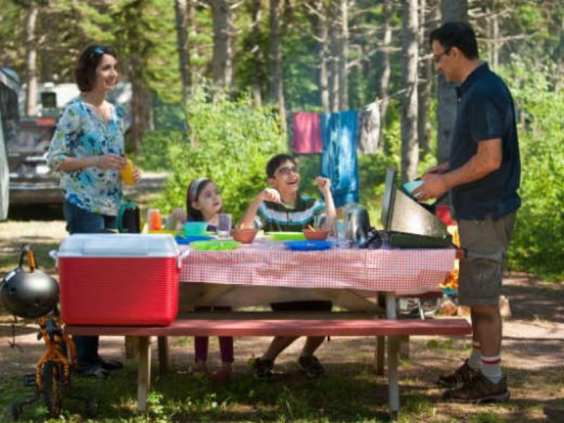 Family cooking meal at picnic table, Stanhope Campground