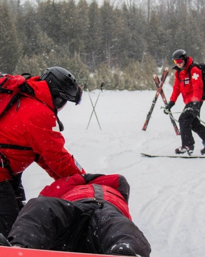 Canadian Ski Patrol doing a hill rescue