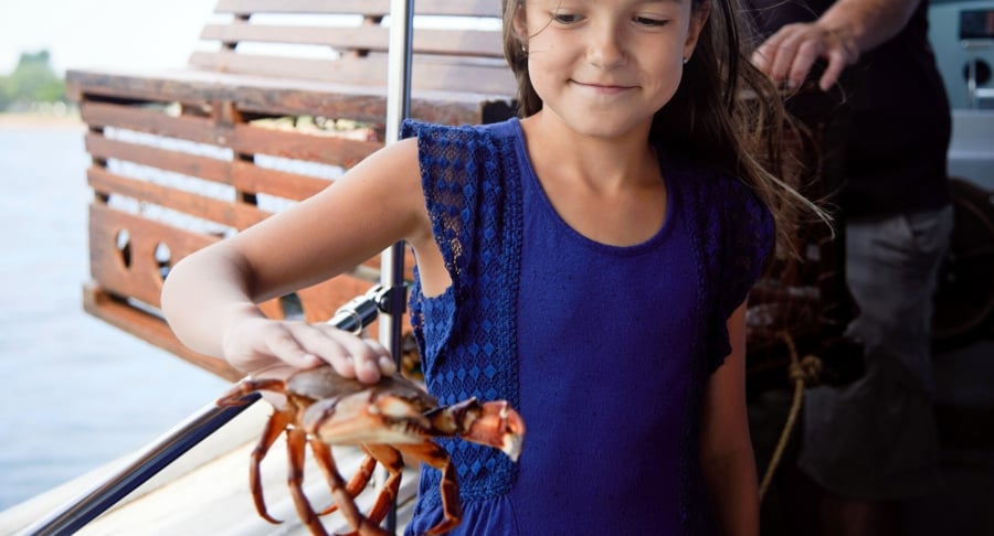 girl holding crab