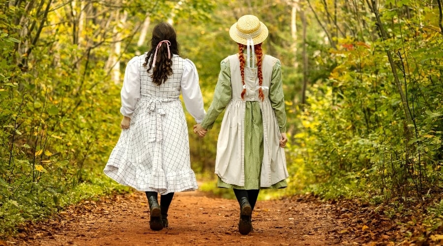 Diana and Anne Shirley walk down Lover's Lane hand in hand under fall colours