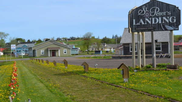 Image of "St. Peter's Landing" sign and shops in background