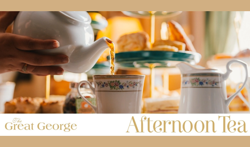 View of tea being poured from tea pot into tea cups