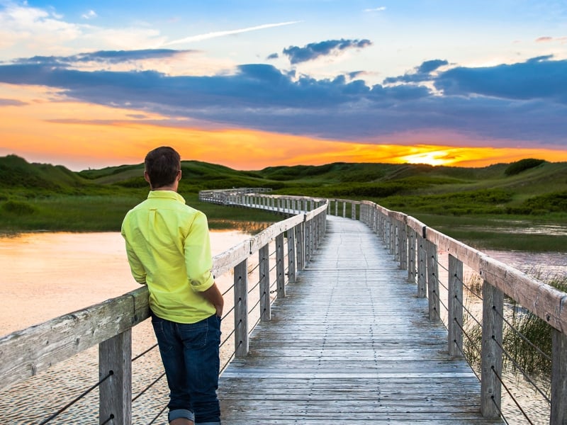 Man standing on Greenwich Boardwalk Sunset
