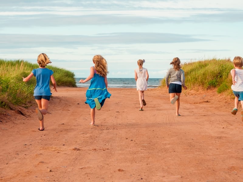 Kids running on sand path, ocean, Rustico