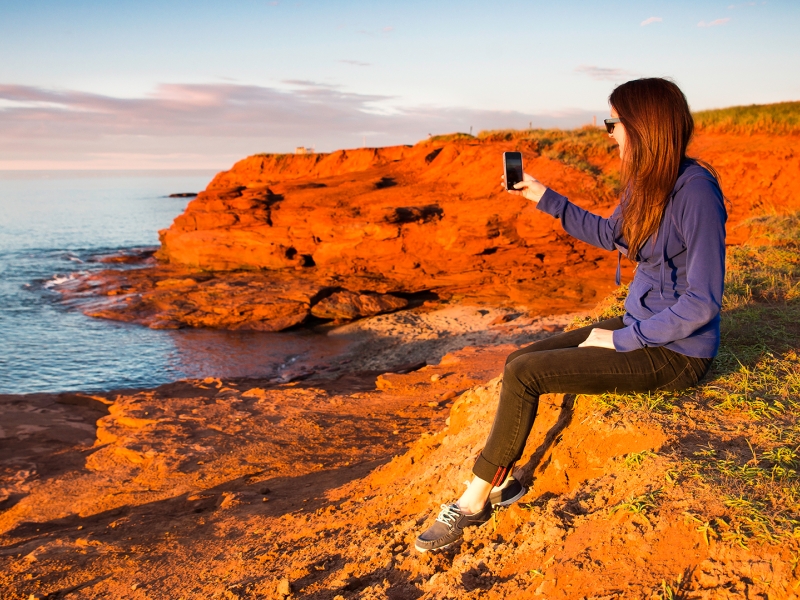 Cavendish Cliffs, woman taking picture Cavendish Cliffs, woman taking picture