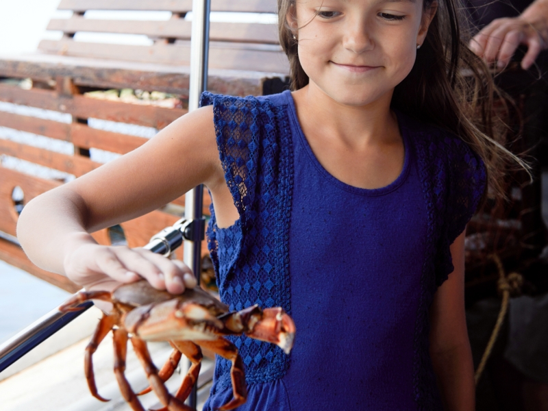 girl holding crab