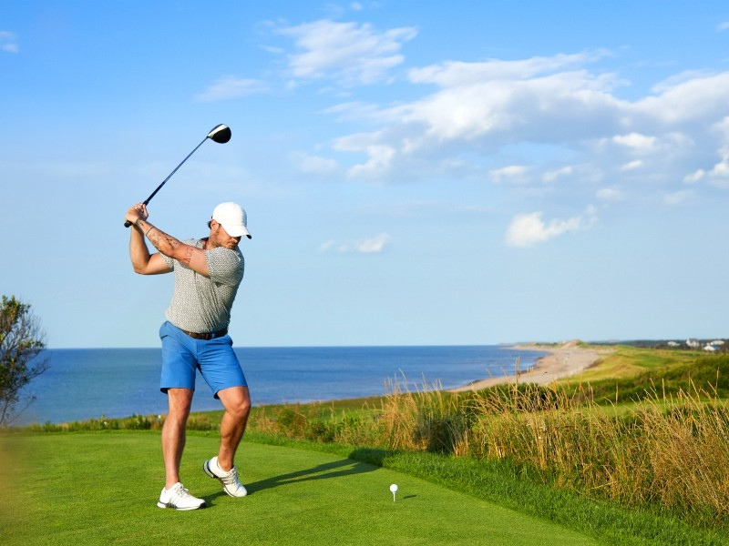 Golf prepares to swing at tee, Crowbush Golf Course