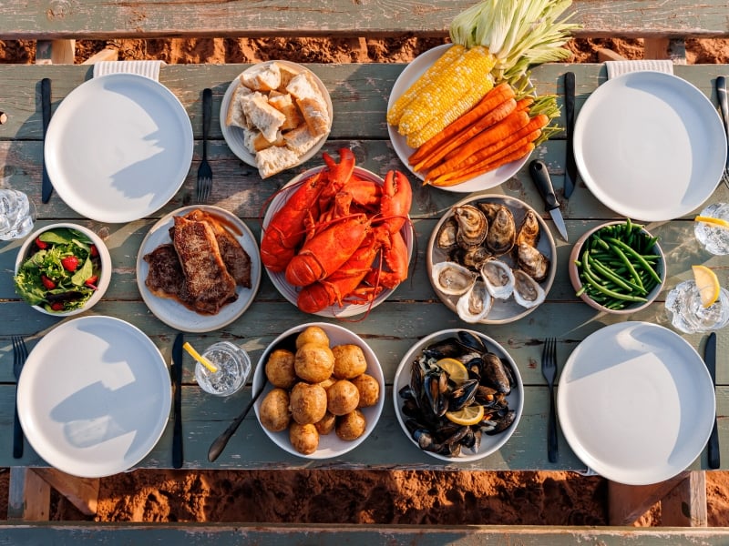 Overhead view of PEI picnic with lobster, potatoes, mussels, chicken, corn. et