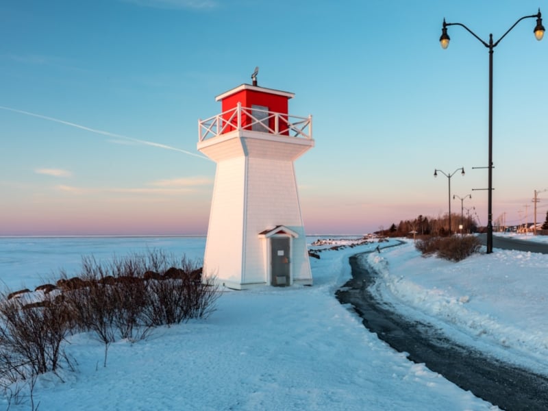 Summerside Lighthouse next to boardwalk at sunset in winter