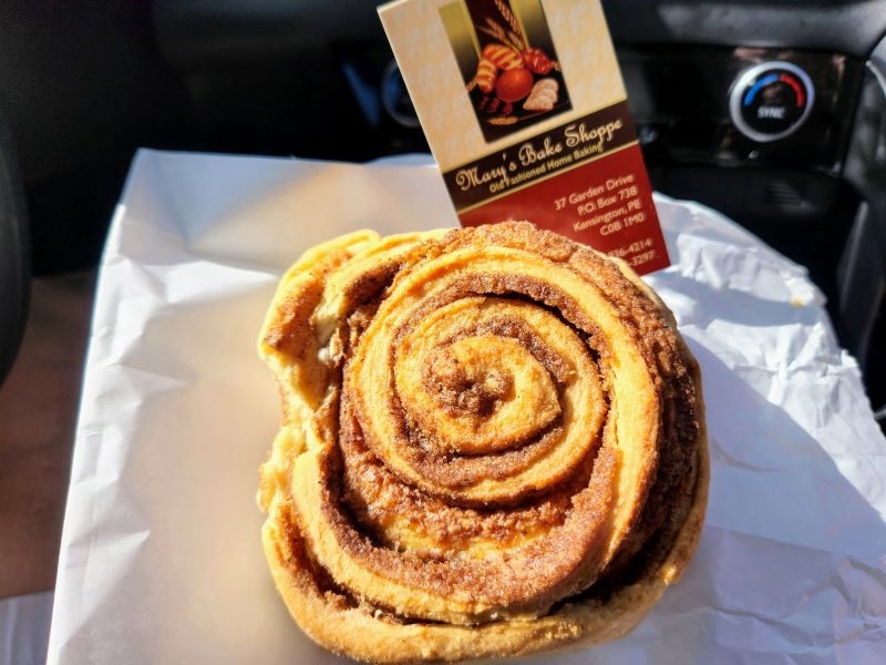 Cinnamon roll pictured with business card in car