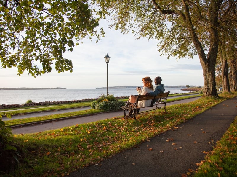 Couple sitting on park bench in Victoria Park