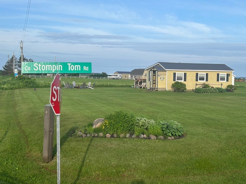 photo of yellow cottage on a landscaped lot