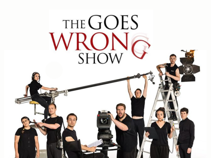 Image of stage crew wearing black with a bomb mike and text "The Goes Wrong Show"