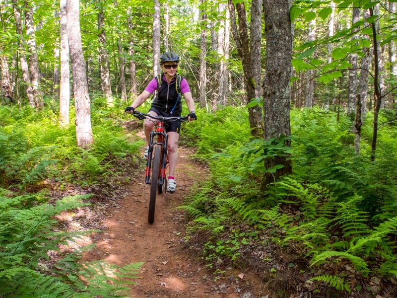 Female on mountain bike trails at Bonshaw Provincial Park, PEI