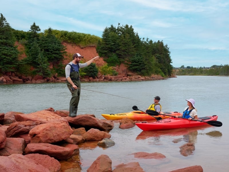 Angler greets two kayakers at Basin Head