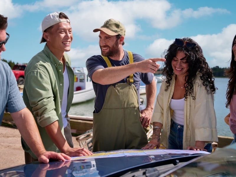 Fisher with group of visitors providing directions