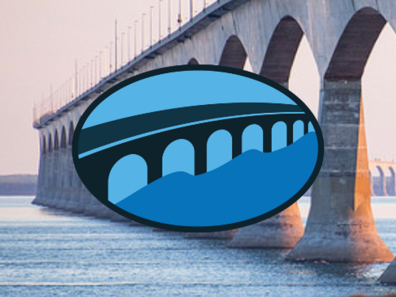 Aerial view of Wood Islands in background with Blue graphic image of Confederation Bridge in oval shape in foreground