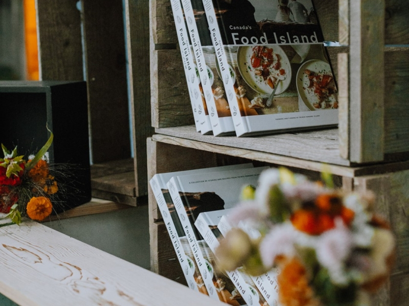 Canada's Food Island Cookbooks on display in wooden crats