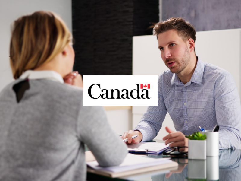 Stock image of two people meeting with Government of Canada logo in center