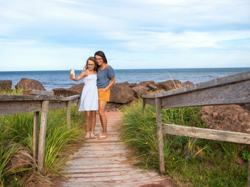Cedar Dunes Provincial Park Campground Woman and child pose for a photo on the boardwalk at Cedar Dunes Provincial Park Campground