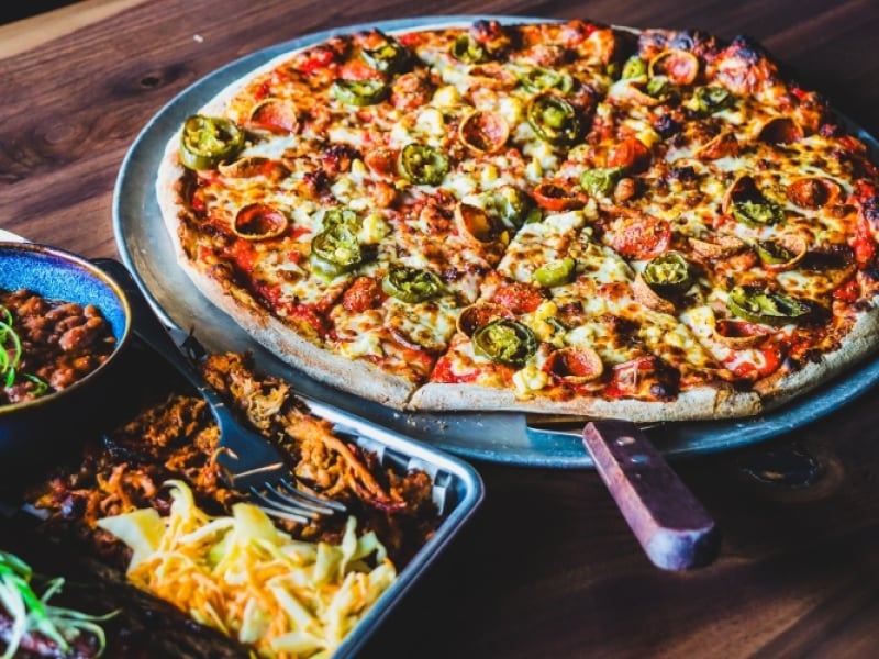 Sampling of menu items including pizza, baked beans and pulled pork from Crafters and Famous Peppers Pizza