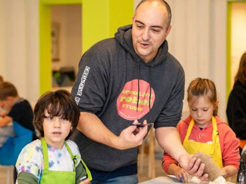 Patrick Guindon assists children in his art studio