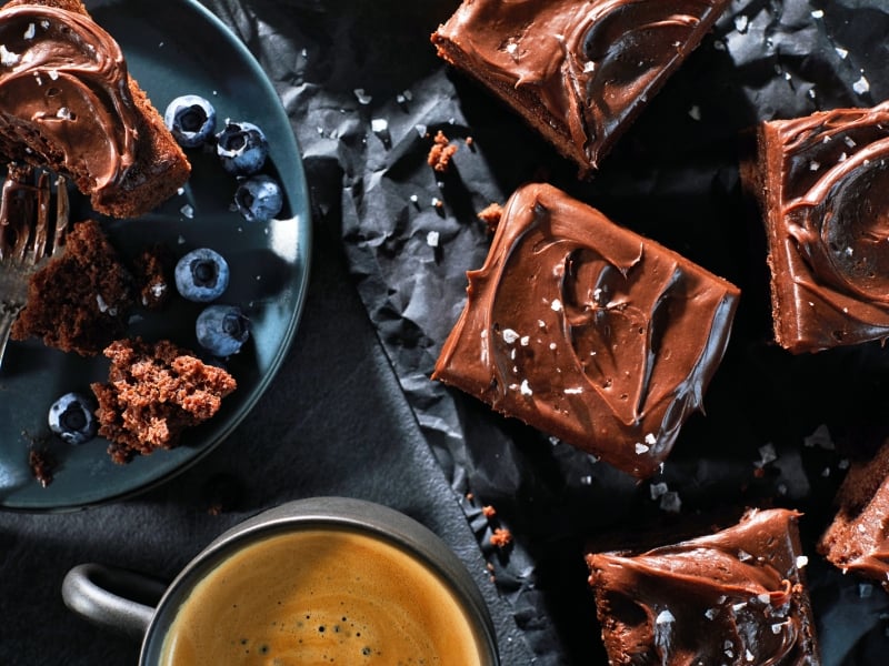 PEI Potato Chocolate squares pictured with a cup of coffee and blueberries