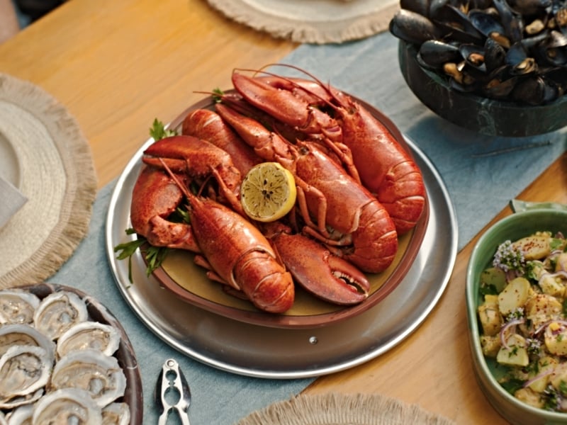 Fall Culinary, PEI Overhead view of table set with cooked PEI lobster, mussels, oysters on the half shell and PEI potatoes