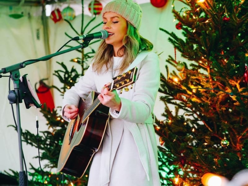 Brooke MacArthur sings and plays guitar during Mistletoe Market