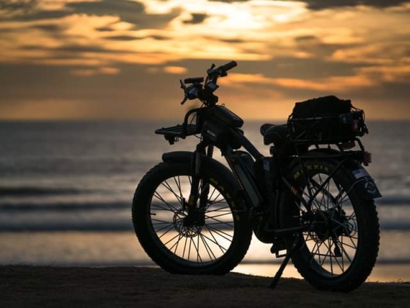 E-bike alone on a beach at sunset