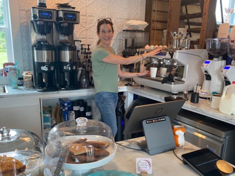Operator makes a latte in kitchen of Foxy Fox Coffee House & Boutique