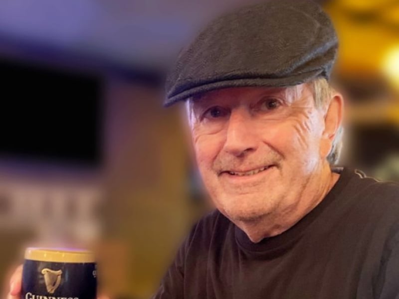 Portrait image of Frank Gillian holding a glass of Guinness beer