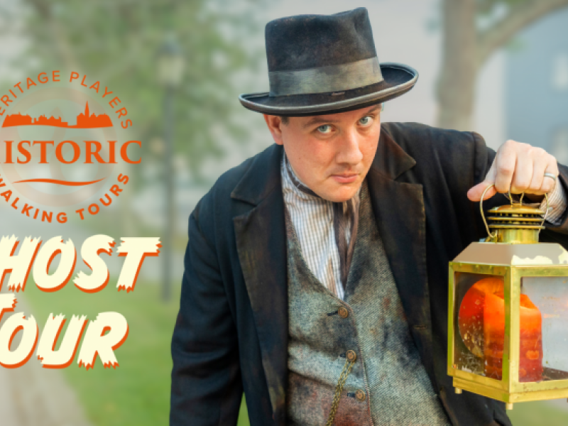 photo of a gentleman dressed in 1800's costume holding a latern