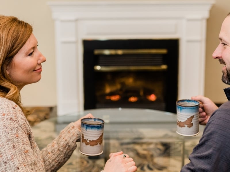 Couple in front of fireplace in hotel room