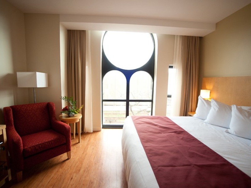 Guest room with large exterior window at the Holman Grand