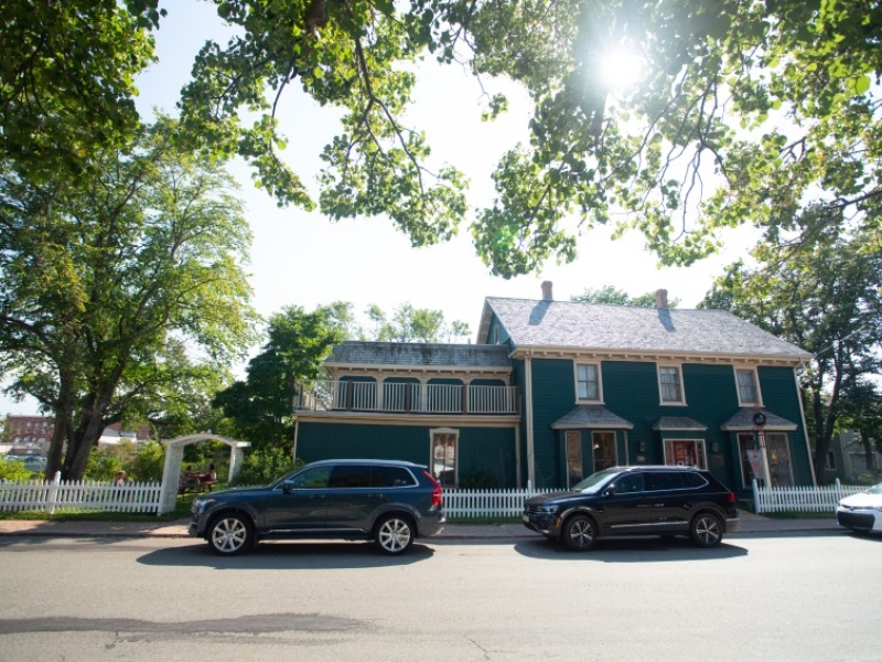 Outside street view of Holman's Heritage Suites, large two storey blue building