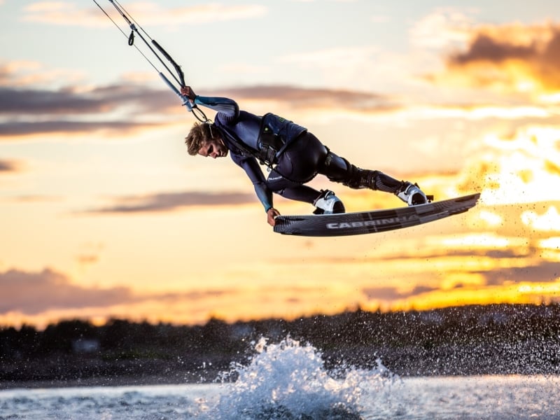 Kiteboarder gets air at sunset