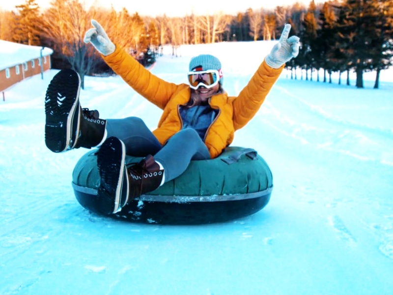 Person on top of tubing hill in tube