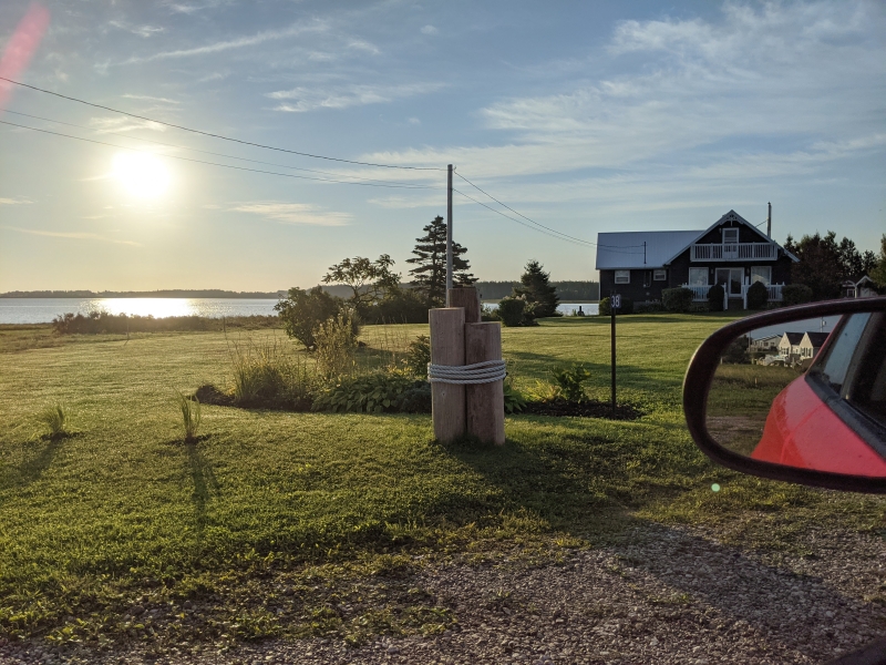 Photo at sunset looking at the grounds of Jenn's Brackley Beach cottage