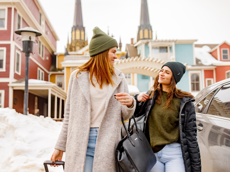 Two females with luggage on Great George St, Charlottetown in winter