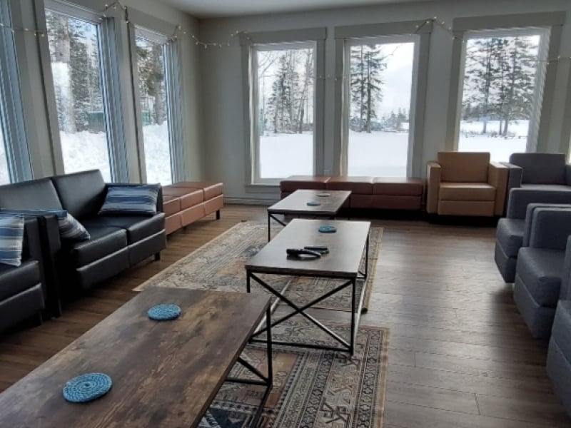 Large sitting room with big windows and views of winter