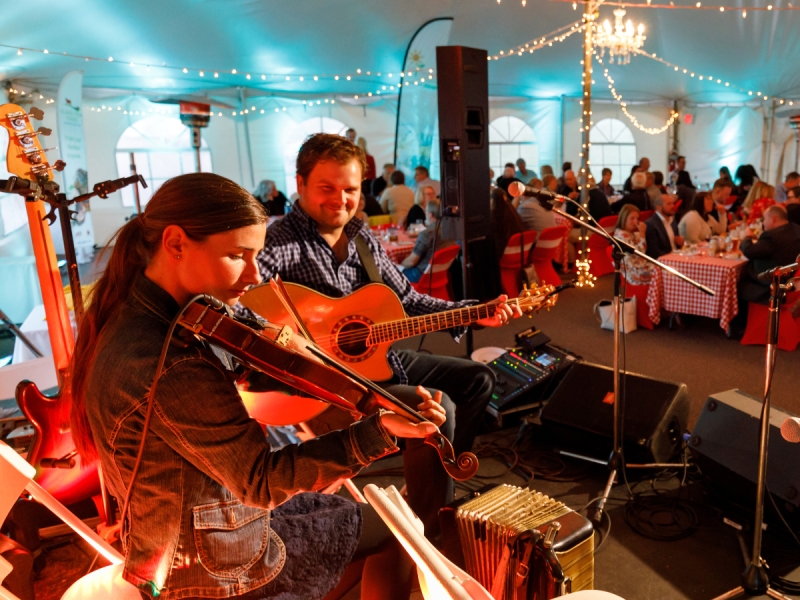 Duo plays music on stage under tent at PEI Shellfish Festival