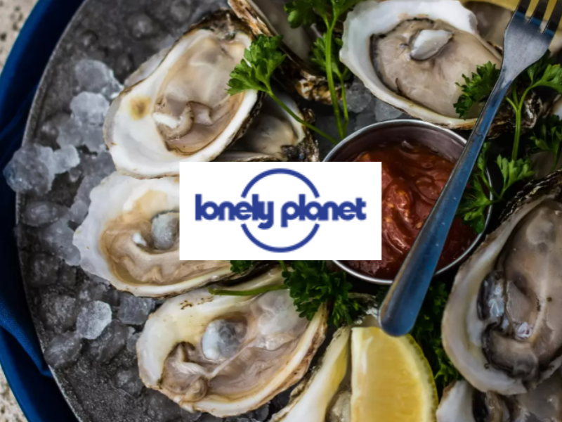 PEI Oysters on the half shell on bed of ice with sauce and lemon
