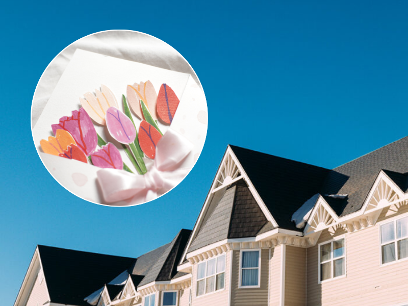 Exterior image of inn in background with stock image of handcrafted tulip greeting card in front