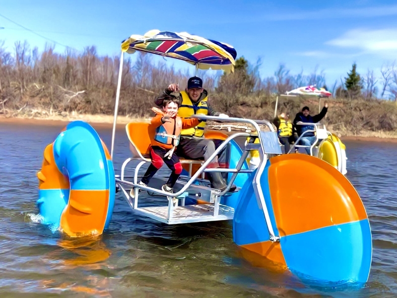 Man and child on water trike 