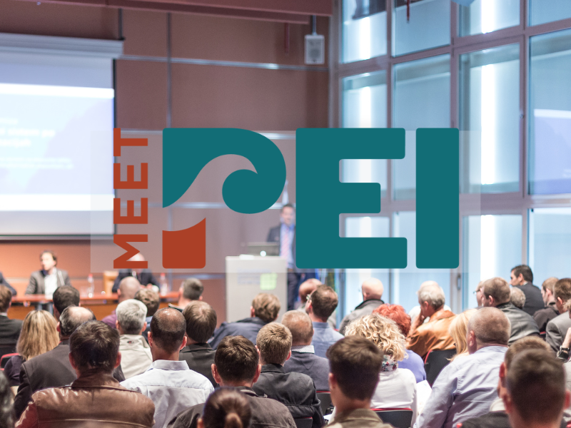 Stock image of meeting in convention setting with Meet PEI logo in foreground
