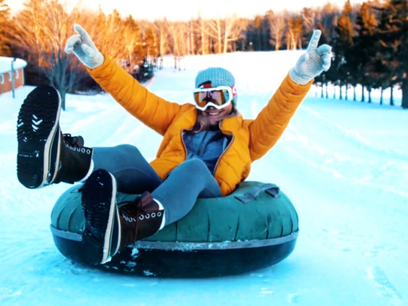 Person on tube at top of sledding hill at Mill River REsort