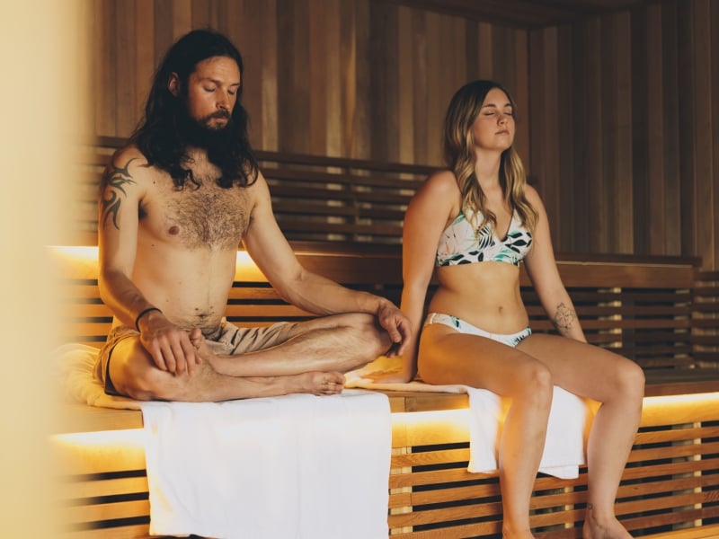 Couple sit in sauna at Mysa Spa