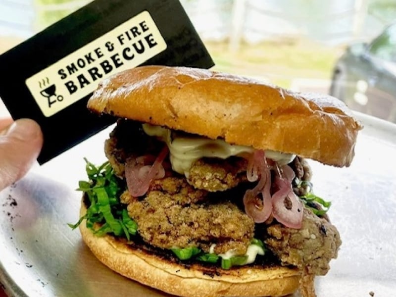Oyster Po Boy Sandwich on platter with Smoke & Fire BBQ gift card in background